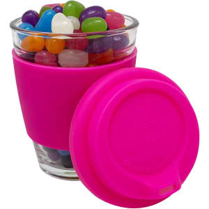 A Carlo glass coffee cup filled with colourful jelly beans, featuring a bright pink silicone sleeve and lid.