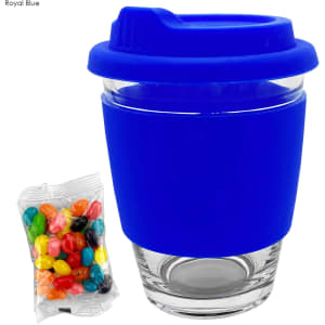 A royal blue glass coffee cup with a silicone lid and sleeve, accompanied by a packet of colourful jelly beans.