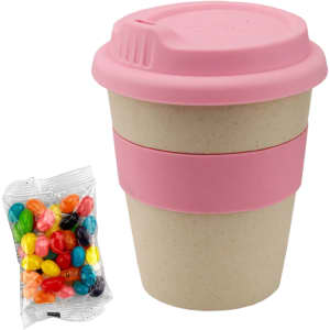 A bamboo cup with a pink lid and band, accompanied by a bag of colourful jelly beans.