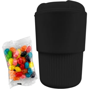 A reusable black coffee cup with a ribbed design beside a pack of colourful jelly beans, featuring a logo.