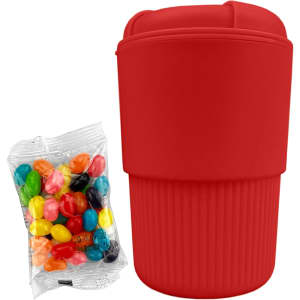A red reusable coffee cup with a silicone sleeve and a packet of colourful jelly beans beside it.