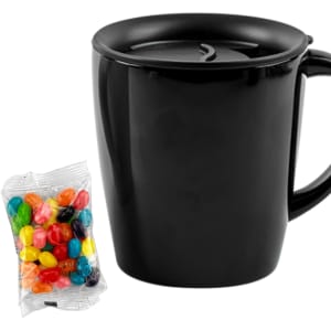 A black mug with a lid alongside a pack of colourful jelly beans. The mug has a simple design and a handle.