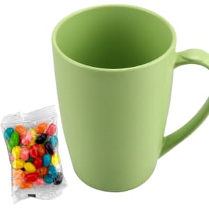 A green bamboo mug next to a pack of multicoloured jelly beans. The mug features a handle and a smooth finish.