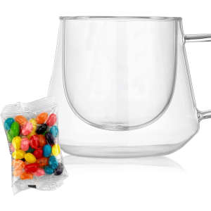 A clear coffee cup with a unique diamond shape alongside a packet of colourful jelly beans.