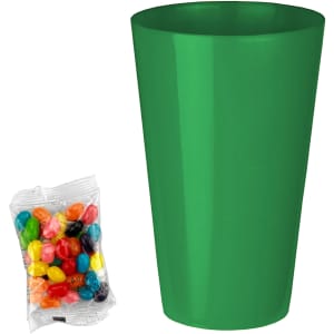 A bright green party cup next to a bag of colourful jelly beans in various shades. The bag is transparent.