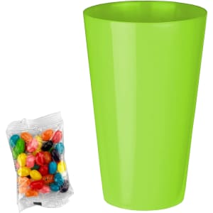 A bright green cup next to a packet of assorted jelly beans in various colours.