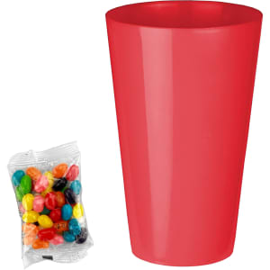 A red party cup next to a packet of colourful jelly beans featuring various shades and patterns.