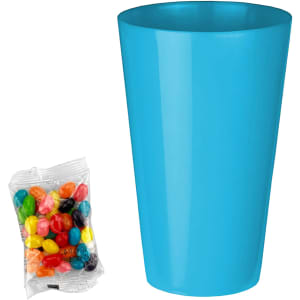 A blue party cup next to a pack of multicoloured jelly beans in assorted shades.