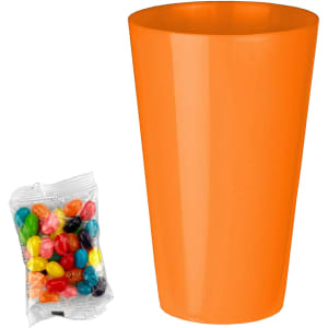 An orange party cup beside a clear packet of assorted jelly beans in various vibrant colours.