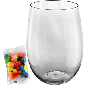 A clear plastic cup with a rounded base beside a bag of multicoloured jelly beans.