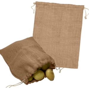 A jute bag in a natural brown colour, featuring a drawstring closure, with some potatoes inside.