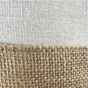 A jute bag featuring a textured natural fibre design with a light-coloured top section and a woven jute bottom.