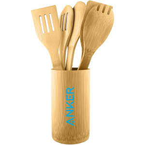 A bamboo cutlery set in a matching holder, featuring four utensils including a spatula, spoon, and slotted spatula.