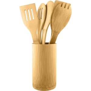 A bamboo cutlery set with a variety of utensils in a matching holder, featuring a warm, natural colour.