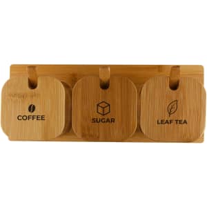 Three bamboo jars labelled for coffee, sugar, and leaf tea, mounted on a wooden base. Each jar has a circular design.