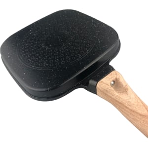 A square grill pan with a non-stick black surface and a wooden handle. It features a textured pattern on the base.