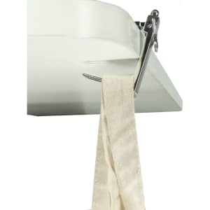 A mobile stand and hanger key ring in silver, attached to a white surface, holding a beige fabric strap.