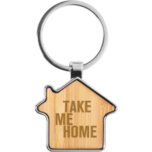 A bamboo key ring shaped like a house with a silver keychain attachment and a logo.