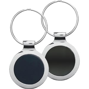 A silver key ring with a circular design featuring a dark, mirror-like surface on one side and a plain surface on the other.