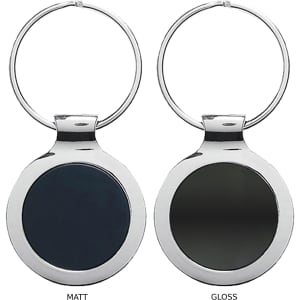 A keyring featuring a round metal design in glossy and matte finishes, with a silver ring attachment.