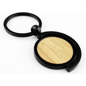 A black key ring with a circular bamboo disc at the centre, featuring a modern design.