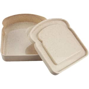 A bamboo sandwich box in a light beige colour, featuring a removable lid shaped like a slice of bread, with a logo.