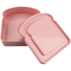 A pink bamboo sandwich box with a lid shaped like a slice of bread. Features a smooth interior and a logo.