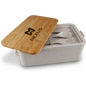 A bamboo lunch box with a light-coloured base and a bamboo lid, containing utensils inside. Contains a logo.