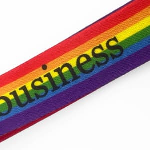 A lanyard featuring a vibrant rainbow design, prominently displaying the word "business" in black text.