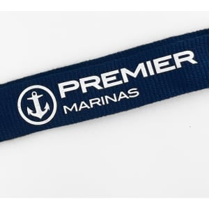 A navy bamboo lanyard featuring a logo, designed for exhibitions and events.
