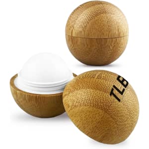 A bamboo lip balm ball in a natural wood finish, featuring a secure two-piece design with a white balm core.