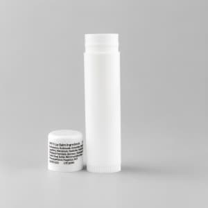 A white lip balm container and a small white cap, featuring an unobtrusive logo.