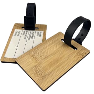 A bamboo luggage tag with a black strap, featuring a blank area for personal information.
