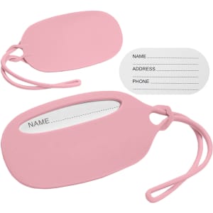 A pink silicon luggage tag with a transparent window for information and an additional blank insert for details.