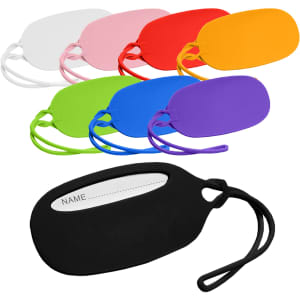 A set of colourful silicone luggage tags in black, pink, red, orange, purple, blue, and white with a slot for a name.
