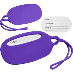 A purple silicone luggage tag with a white insert for personal information and a loop attachment.