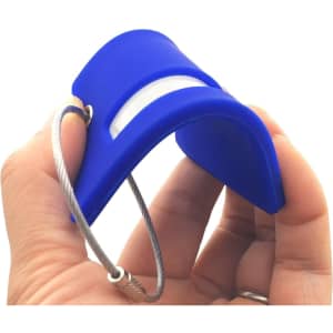 A blue silicone luggage tag held in a hand, featuring a loop for attachment and a smooth surface.