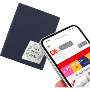 A navy notebook with an NFC tag is displayed alongside a smartphone scanning a webpage.