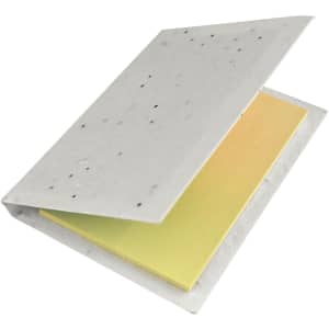 A sticky note pad featuring yellow notes enclosed in a textured white cover with visible speckles.