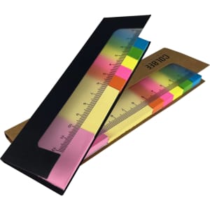 A sticky note pad featuring a ruler design with vibrant pink, yellow, and blue sections, packaged in a brown holder with a logo.