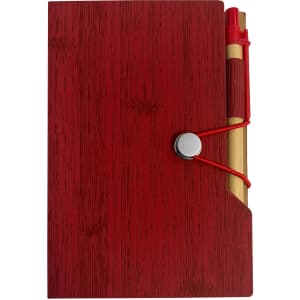 A red sticky note pad with a textured finish, featuring a pen secured by an elastic band on the side.