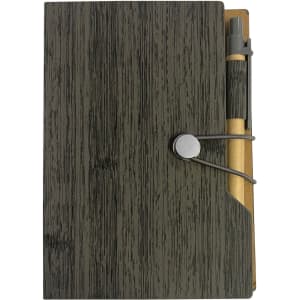 A green wooden-textured sticky note pad with a pen secured by a band. The design includes a pocket for loose notes.