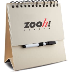 A white memo whiteboard notepad with a spiral binding and a black marker, featuring a logo on the front.