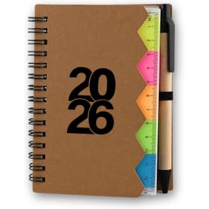 A brown spiral-bound notebook with a ruler and colourful tabs, featuring the year "2026" on the cover.