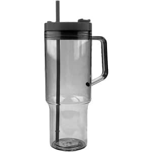 A travel mug in transparent grey with a handle and a straw, featuring a dark lid.