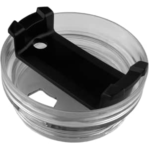 A clear travel mug with a black grip holder, featuring a circular opening and a sleek design.