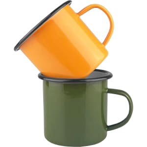 An orange enamel camper mug stacked on a green enamel camper mug, both featuring black rims and handles.