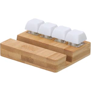 A bamboo stand featuring four white keyboard keys, designed as a stress reliever.