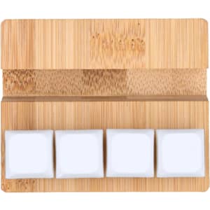 A bamboo stand featuring three white square stress reliever blocks on a smooth surface.