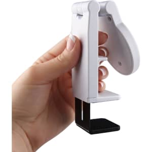 A white mobile phone stand held in a hand, featuring a black base for stability.